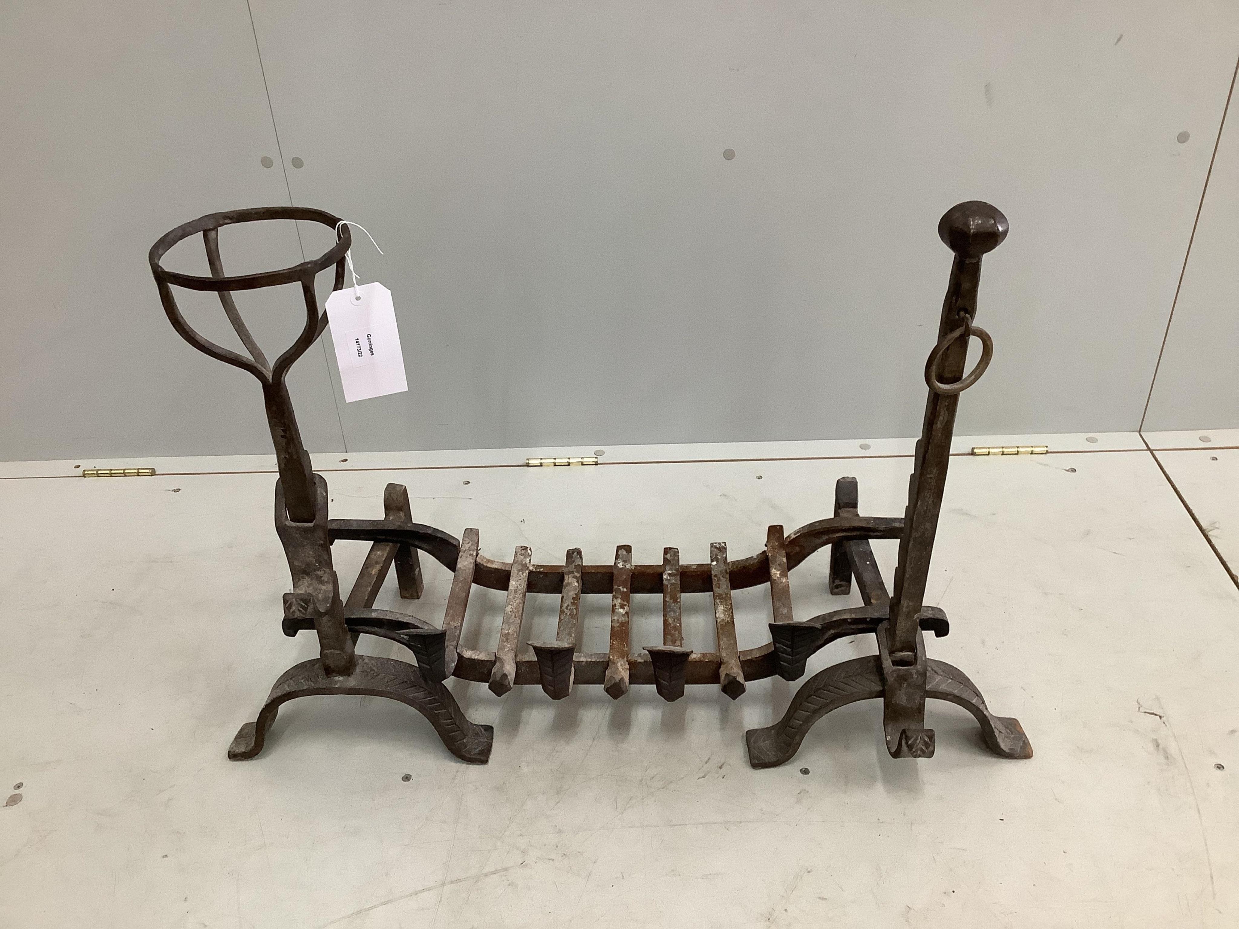 A pair of wrought iron fire dogs and grate, width 82cm, depth 36cm, height 62cm. Condition - good